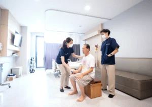 พยาบาลดูแลผู้สูงอายุและติดตามค่าความดันโลหิตที่ศูนย์ฟื้นฟู PNKG